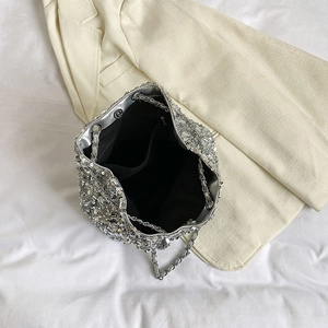 Silver sequin bucket bag with metal chain strap and spacious interior compartment