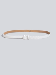 Detailed macro view of white Saffiano leather skinny belt with elegant metal buckle closure
