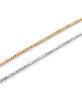 Close-up of gold and silver tennis bracelets with sparkling round crystals on white background