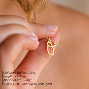 Detail of 14K gold alphabet O pendant with heart on 42cm stainless steel chain