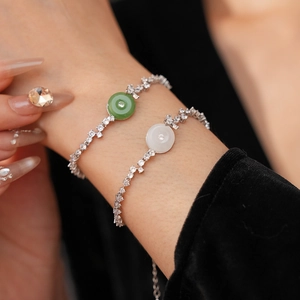 Close-up of zircon chalcedony bracelets with green and white pendants and silver chains