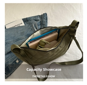 Detail view of olive green quilted crossbody bag showing spacious interior and large capacity