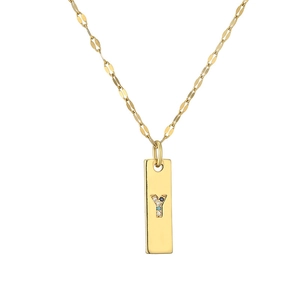 Macro shot of gold-plated rectangular pendant with crystal lowercase letter Y charm