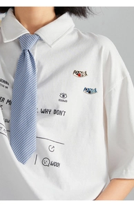 Close-up of cute red and blue carp enamel pins worn on a white shirt lapel