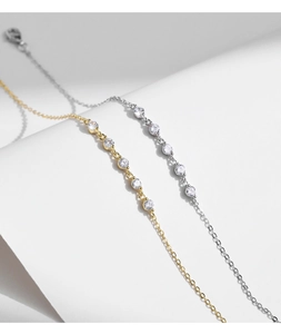 Close-up of gold and silver S925 sterling silver bracelets with sparkling zircon charms