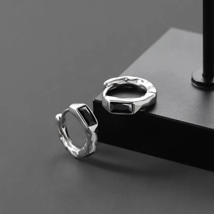 Minimalist silver stud earrings with black rectangle gemstones and textured metal finish