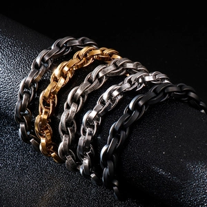 Detail of chunky braided chain bracelets in gold, silver, black, and gunmetal finishes