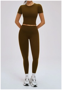 Detail of olive green yoga set showing high waist leggings and short sleeve crop top fabric
