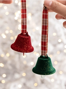 Detail of red and green flocked Christmas bells with gold glitter and plaid ribbons