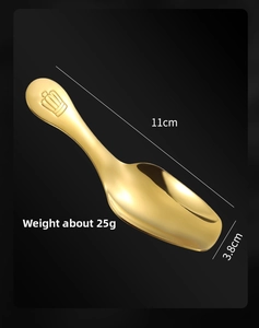 Macro detail of gold stainless steel spoon with crown relief and size measurements