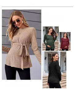 Detail view of maternity sweater featuring ribbed knit texture and adjustable waist belt