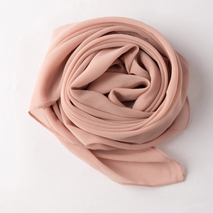 Detailed close-up showing the lightweight texture of a dusty pink chiffon scarf