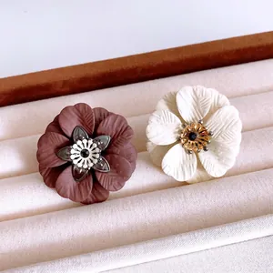 Elegant floral jewelry set featuring deep red and cream petals in a velvet jewelry box