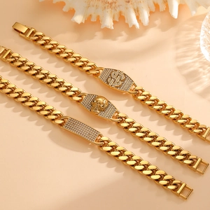 Detailed shot of three gold Cuban link bracelets with dollar, skull, and diamond charms