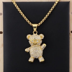 Close-up of golden hip-hop panda pendant with sparkling rhinestones on a gold bead chain