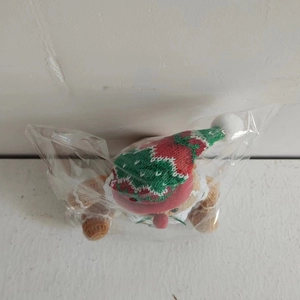 Macro shot of knitted gingerbread man Christmas ornament in a transparent package