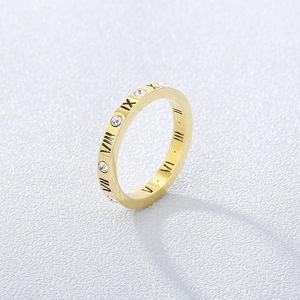 Macro detail of 18k gold roman numeral ring band with inlaid sparkling crystals