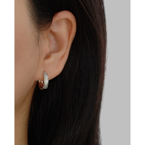 Close-up of S925 sterling silver earring on model showing polished finish and hallmark