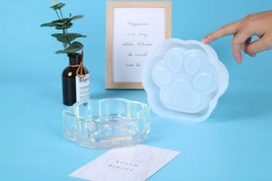 Detail showing cat paw silicone mold with iridescent resin ash tray product