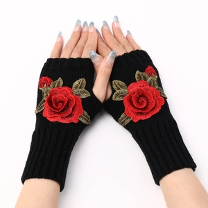 Detail showing knitted black fingerless gloves with elegant red rose embroidery on the back
