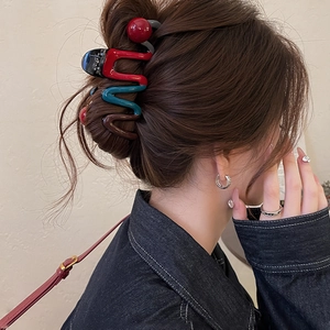 Large wavy multi-color resin claw clip with red bead for elegant hair styling