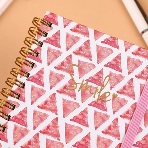Pink watercolor A6 spiral notebook with golden Smile foil text and elastic band closure