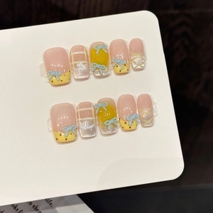 Pink and yellow bow press-on nails with white plaid patterns and 3D blue butterfly accents