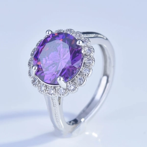 Elegant oval purple gemstone ring with diamond halo and vintage silver band