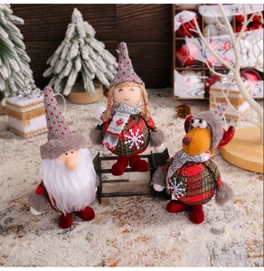 Close-up of Christmas gnome, Santa and reindeer plush ornaments with festive textures