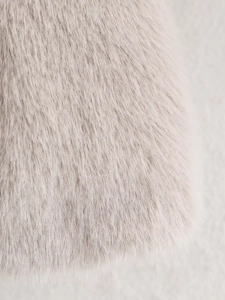 Close-up of the soft light beige faux fur texture on this short winter jacket