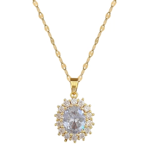 Luxurious gold oval pendant necklace with sparkling crystal set on a fine choker chain