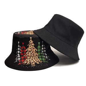 Reversible black cotton bucket hat featuring festive leopard and plaid Christmas trees