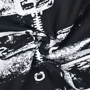 Close-up of knit fabric showing skeleton print and spiral texture on long sleeve top