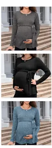 Close-up of maternity knit sweater with round neck and tie-waist detail in three colors