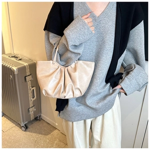 French style ruched cloud bag in beige leather shown on model for size and fit