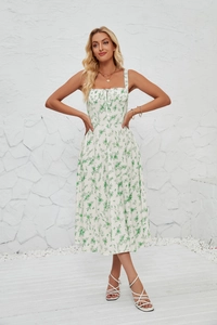 Detail of white floral sundress showing spaghetti straps and lace-up neckline design