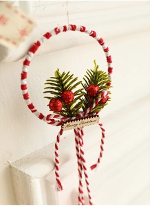 Detail of Christmas tree ornament with red glitter berries and Merry Christmas wooden tag