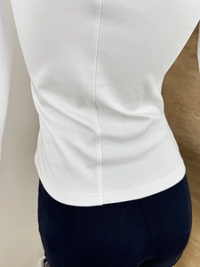 Detail view of back seam and knit texture on white slim-fit three-quarter sleeve top