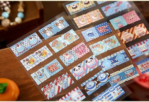 Close-up of vintage Japanese stickers with cute cat and dessert patterns on a wooden surface