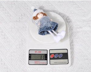 Weight measurement of the Christmas plush angel doll showing approximately 11g