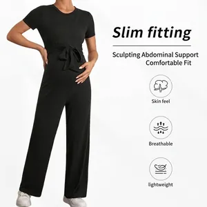 Slim fit black maternity jumpsuit with short sleeves, ribbed texture, and waist tie