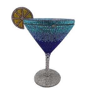 Macro detail of martini glass shaped clutch with blue gradient crystals and lemon slice decor