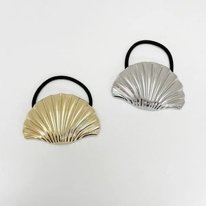 Close-up of gold and silver shell hair ties with high-elastic black rubber bands