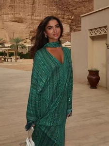 Elegant emerald green long-sleeve maxi dress with sequin geometric patterns and tassels