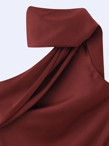 Macro shot of dark red satin fabric with elegant drapery detail on a midi dress
