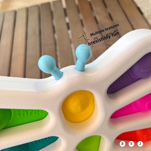 Close-up of sensory toy showing colorful silicone bubbles with numbers and textures