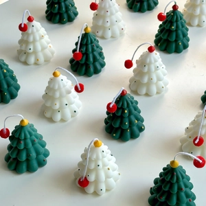Top view of mini Christmas tree scented candles in white and green festive colors