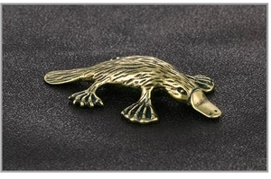 Detailed view of the antique brass platypus figurine with intricate textured hair