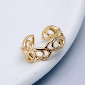 Detailed close-up of adjustable gold eye-shaped ring with hollowed pupil design