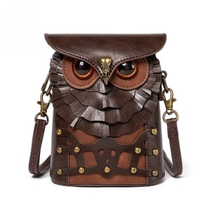 Detailed close-up of a vintage punk owl crossbody bag with layered leather feathers